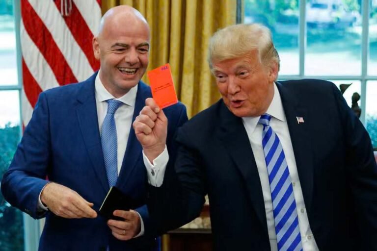 President Trump holding up a red card alongside FIFA President Gianni Infantino
